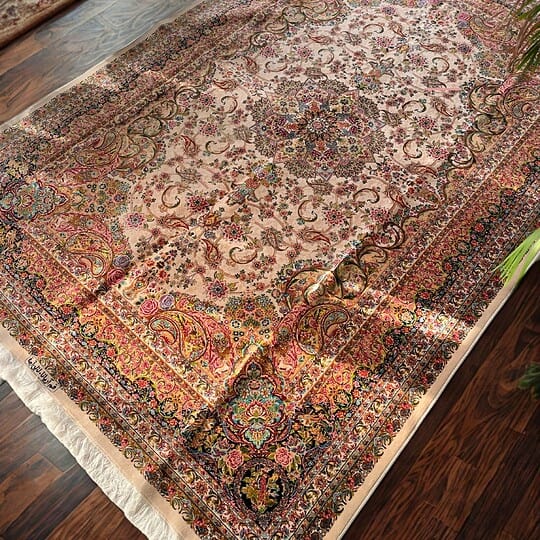 Decorative Silk Persian rug featuring detailed floral motifs and rich colours, perfect for enhancing living room aesthetics.