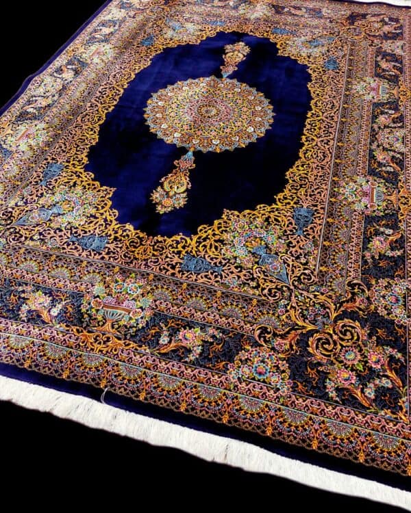 Luxurious Silk Persian rug featuring intricate floral patterns and a central medallion on a deep navy background. Perfect for adding elegance and sophistication to any living space.