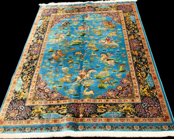 Elegant Silk Persian rug featuring intricate designs of mythical creatures, hunting scenes and floral motifs on a bright blue background. Perfect for adding a touch of luxury and tradition to any space.