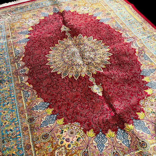 Silk Persian Red rug with intricate patterns and vibrant colours. Perfect for adding a touch of luxury and tradition to any living space.