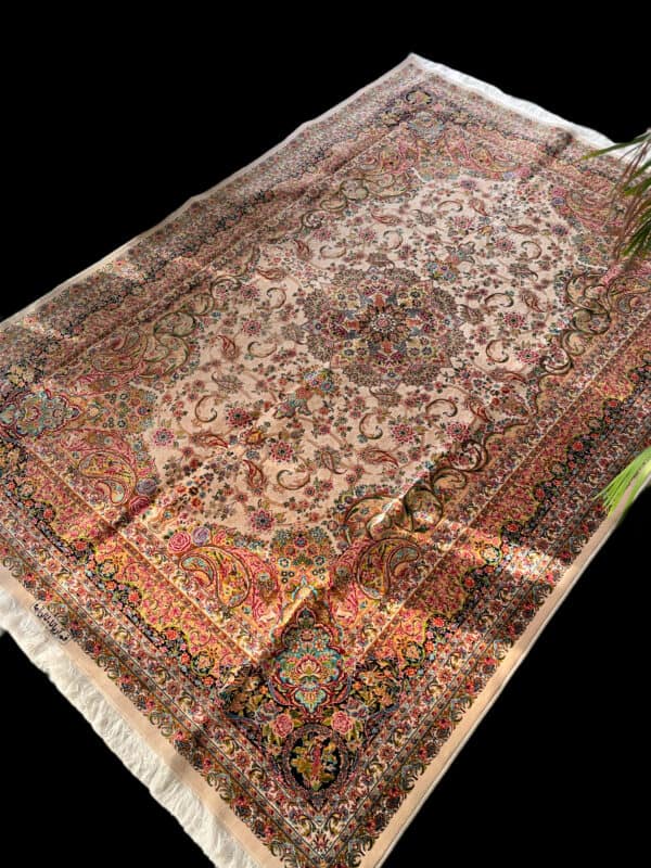 A detailed view of a traditional Silk Persian rug featuring intricate floral and geometric designs in vibrant colors, perfect for adding elegance to any living space.