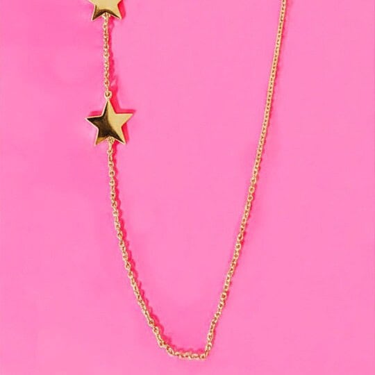 Gold star necklace with three star pendants on a fine chain, perfect for trendy fashion and everyday wear.