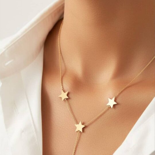Gold star necklace on a woman's neck, stylish jewelry accessory for women, perfect for everyday wear or special occasions.