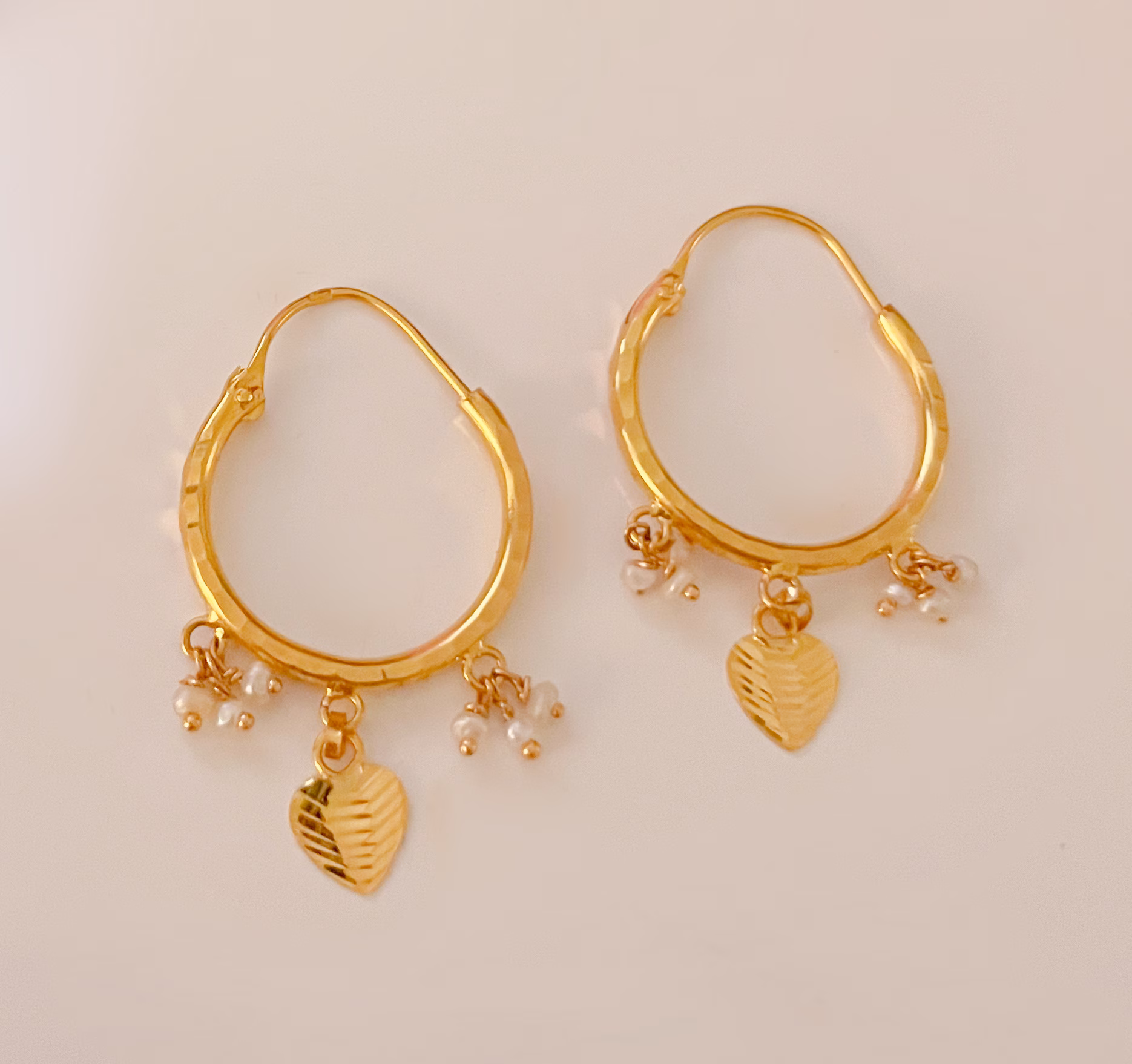 Gold Hoop Earrings with natural Bahraini Pearl Drops and love heart charms.