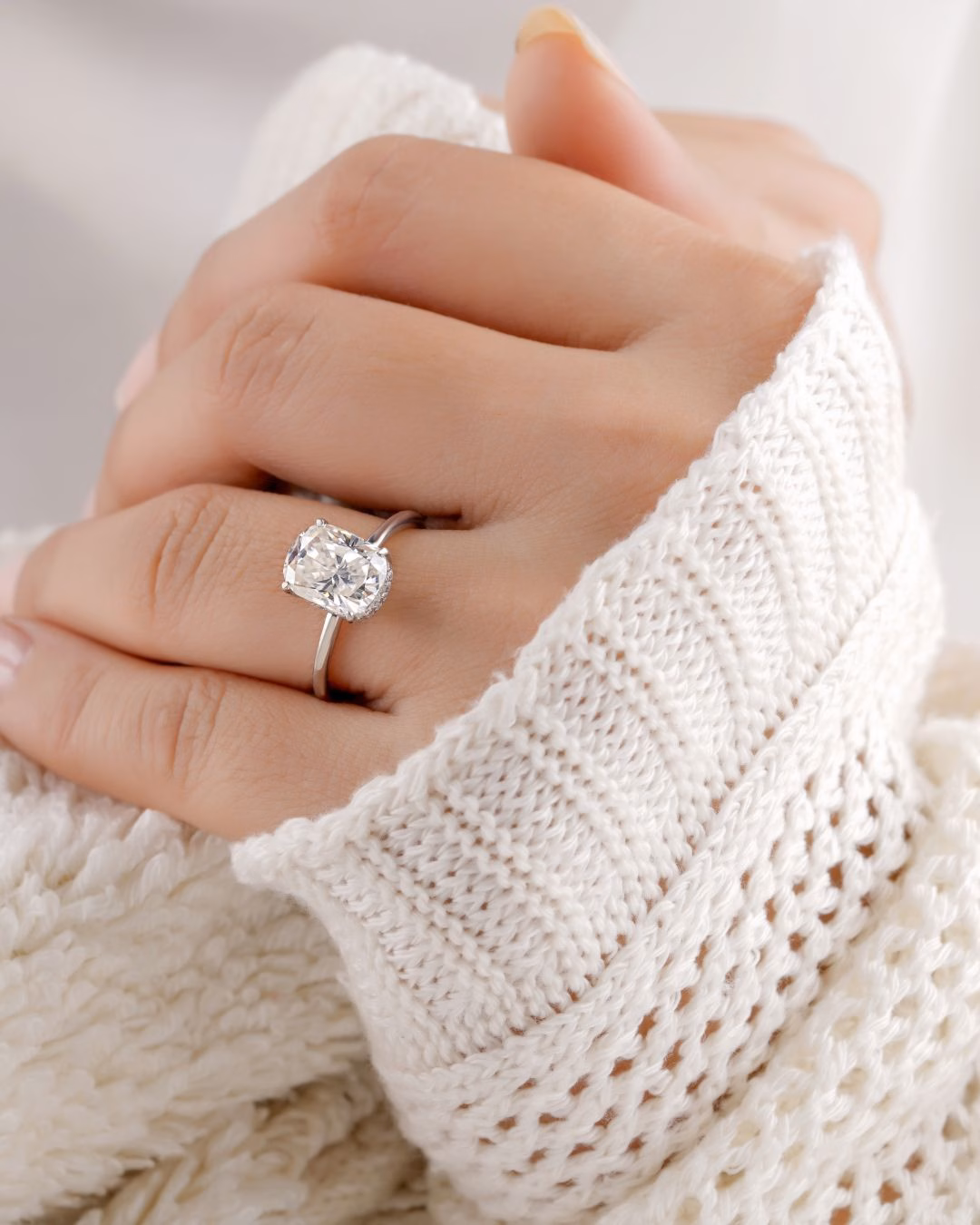 An oval lab diamond ring set in 18K Gold worn and displayed by a model