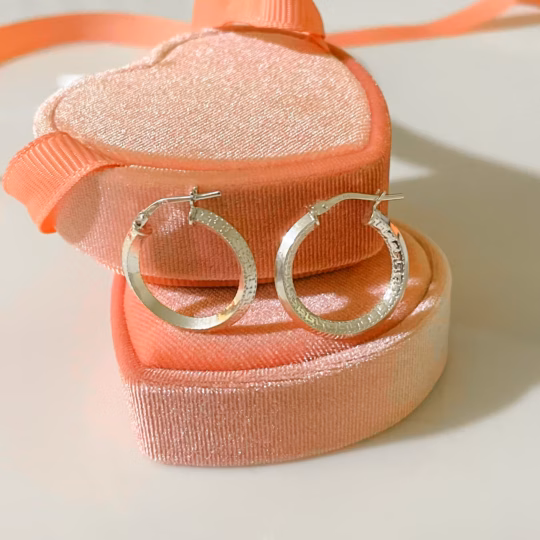 Sterling Silver Hoop Earrings with Greek Key pattern displayed on a pink heart shaped velvet box.