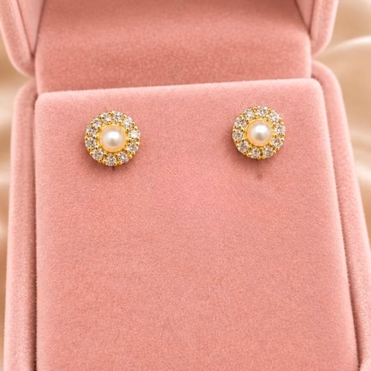 A stunning pair of natural pearl earrings surrounded by diamonds