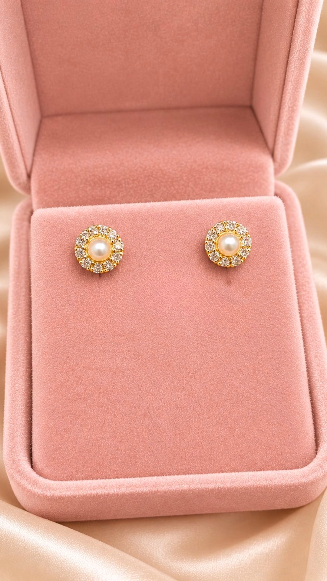 A stunning pair of natural pearl earrings surrounded by diamonds